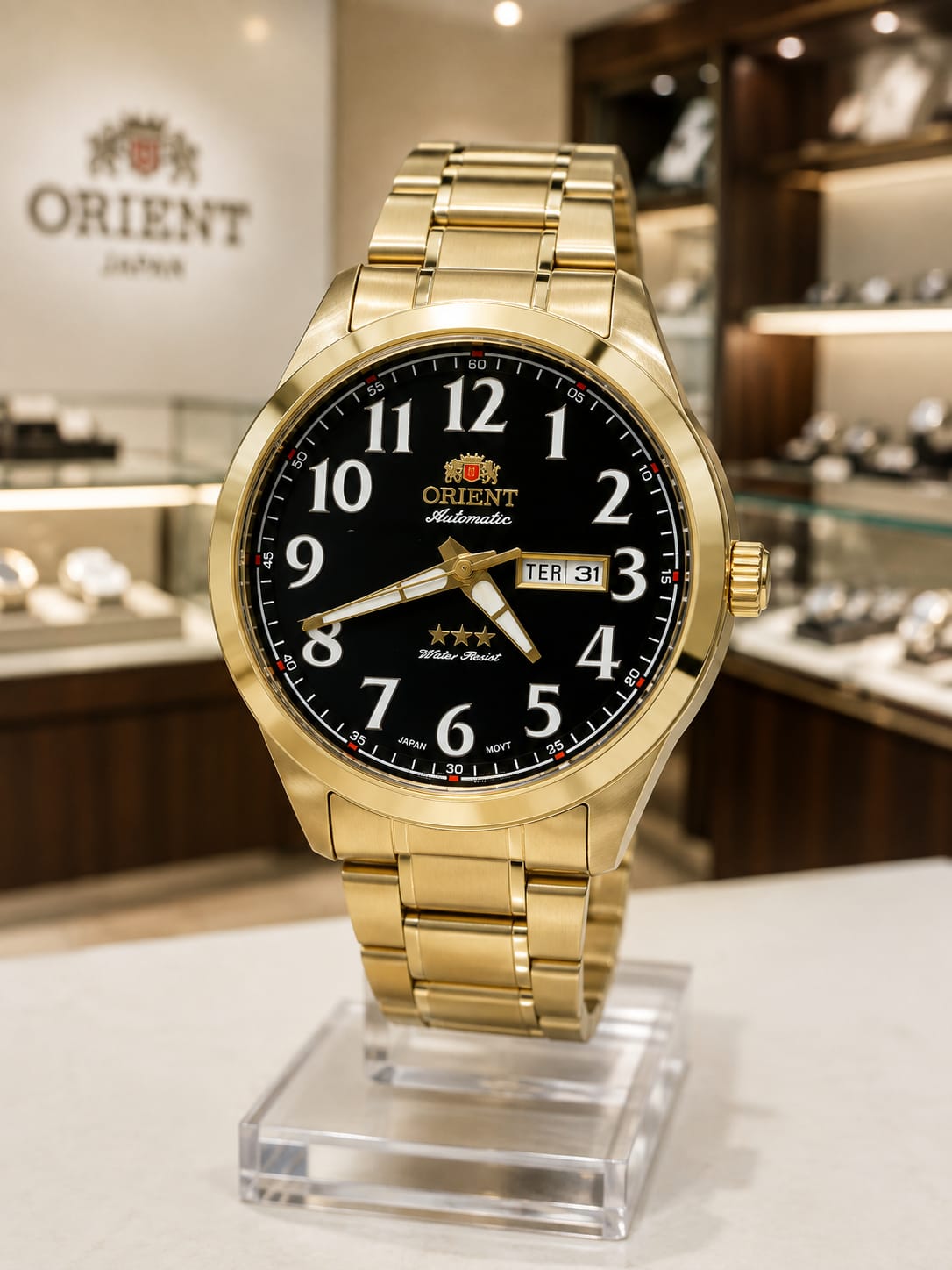 Relógio Orient automático dourado com mostrador preto e número branco grande, calendário - 5atm